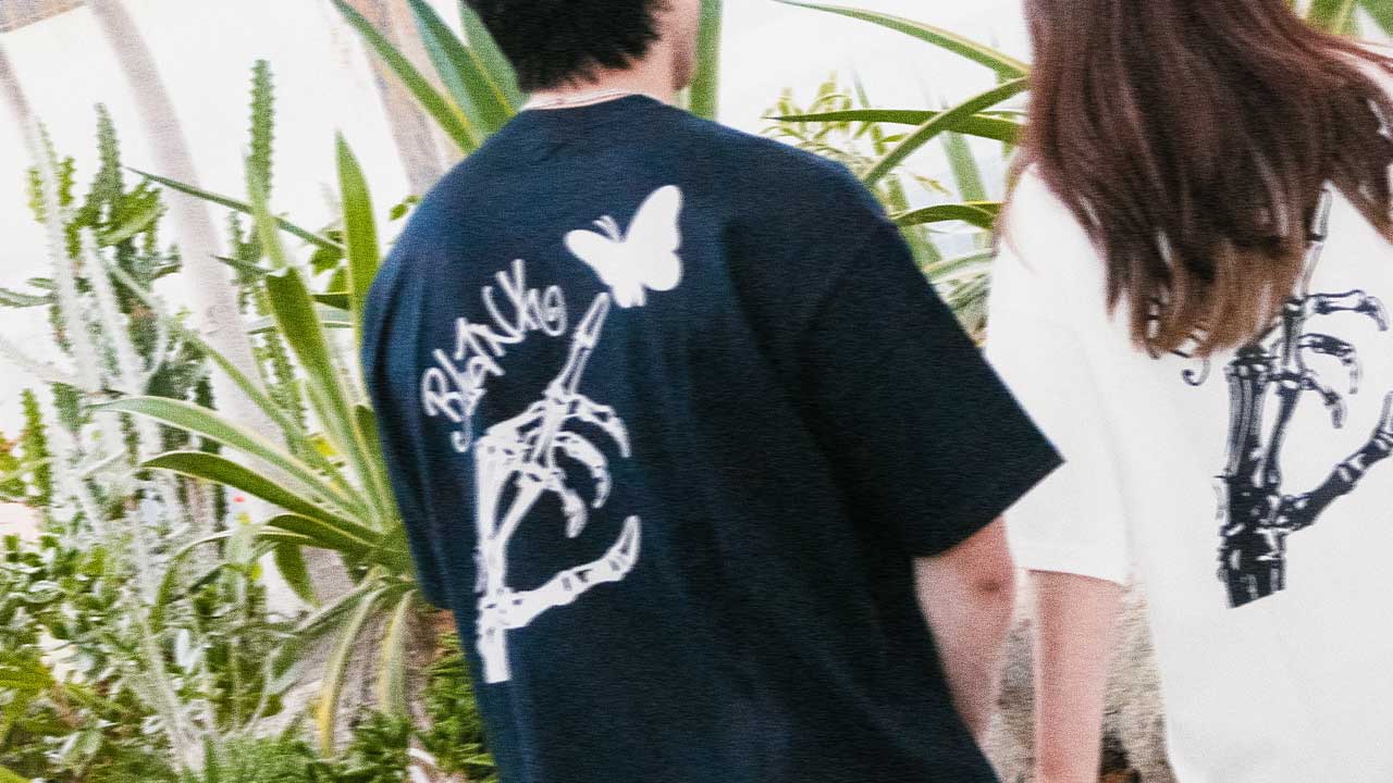 Skeleton hand graphic t shirts worn by models on black and white colors