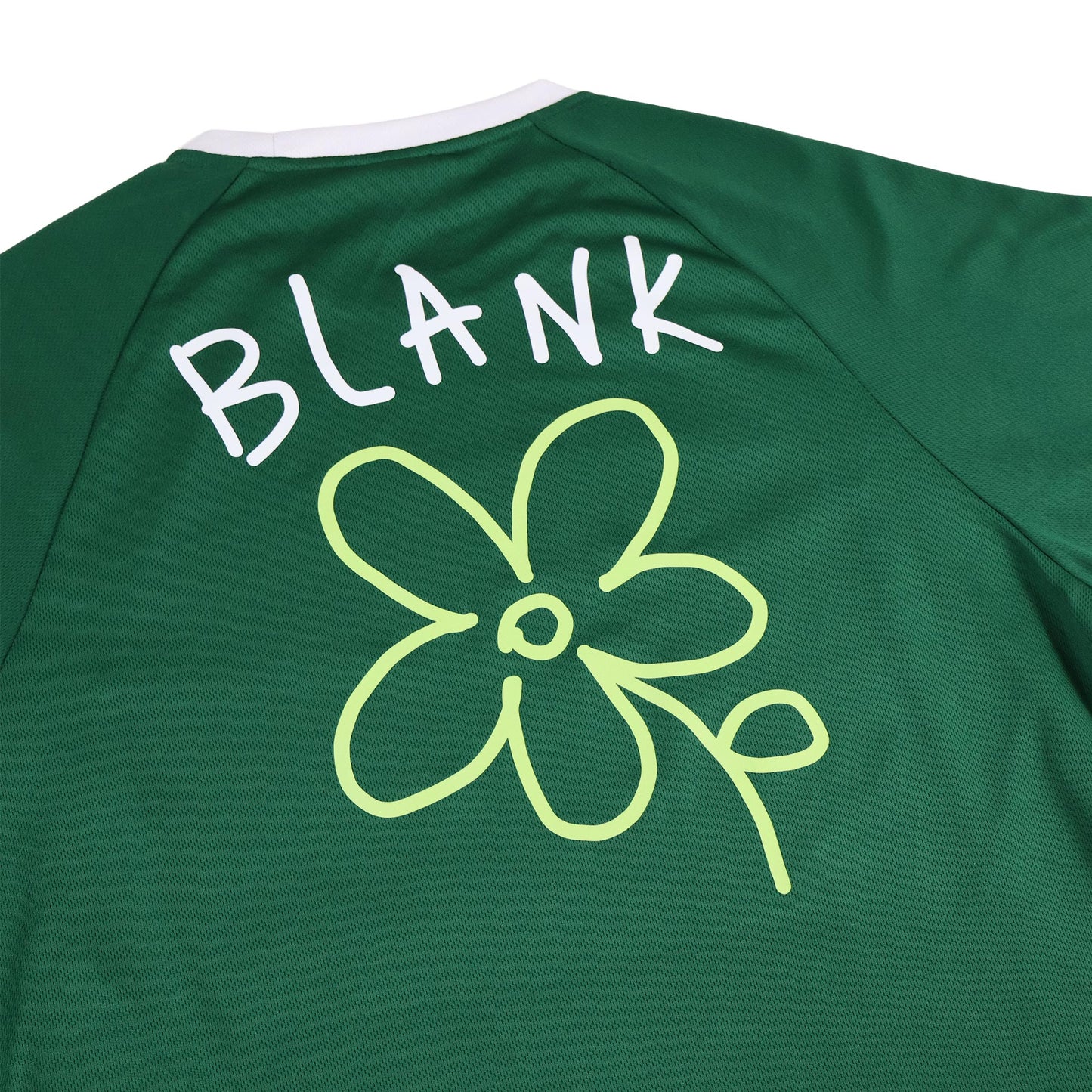 Hand-drawn flower graphic on green football shirt