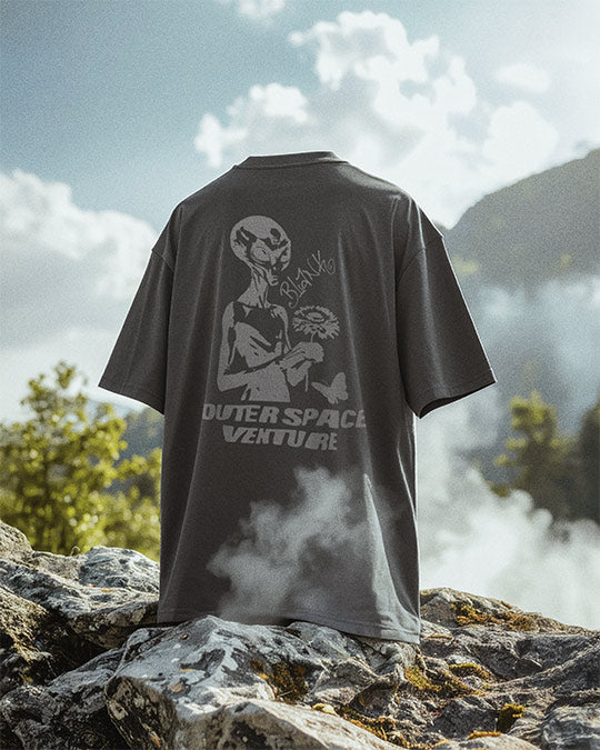 Blank Project alien with flower and butterfly graphic short sleeve t-shirt floats on rocks and nature background