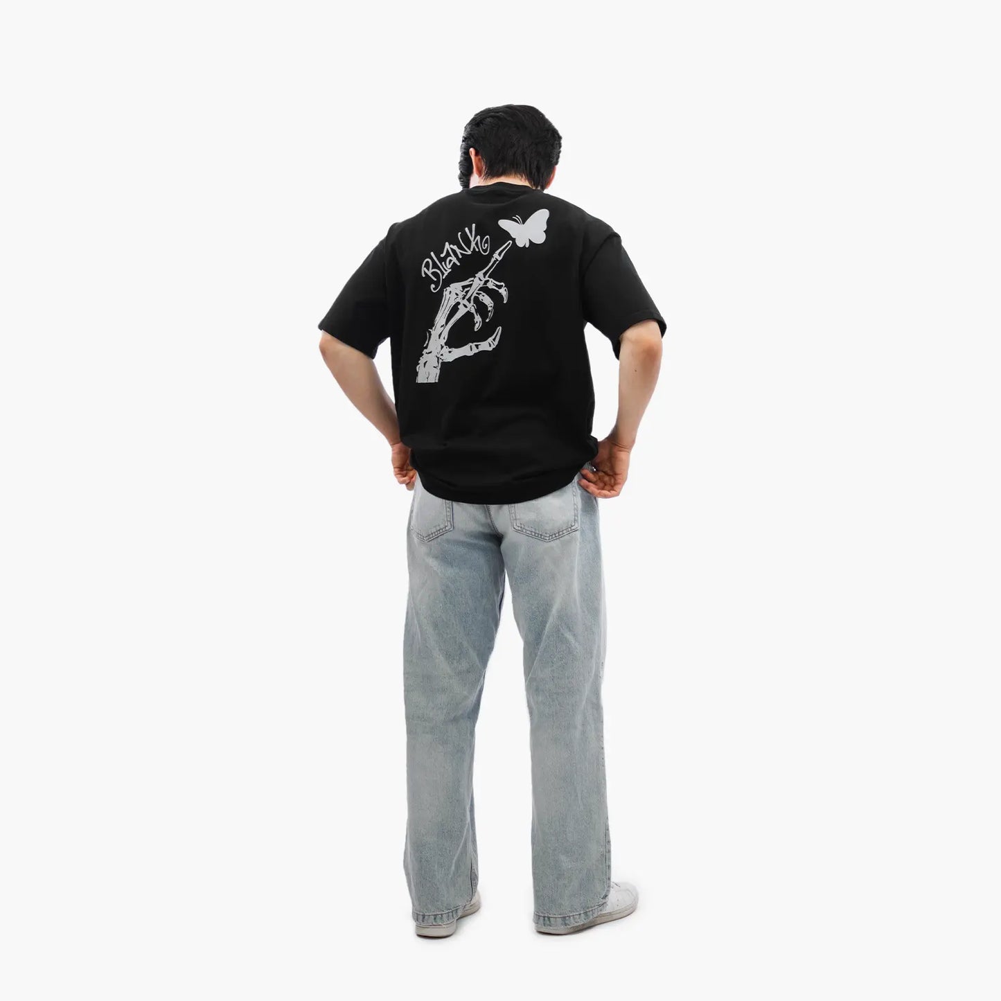 Model wears Blank Project Skeleton Hand Graphic Short Sleeve T-Shirt in black color