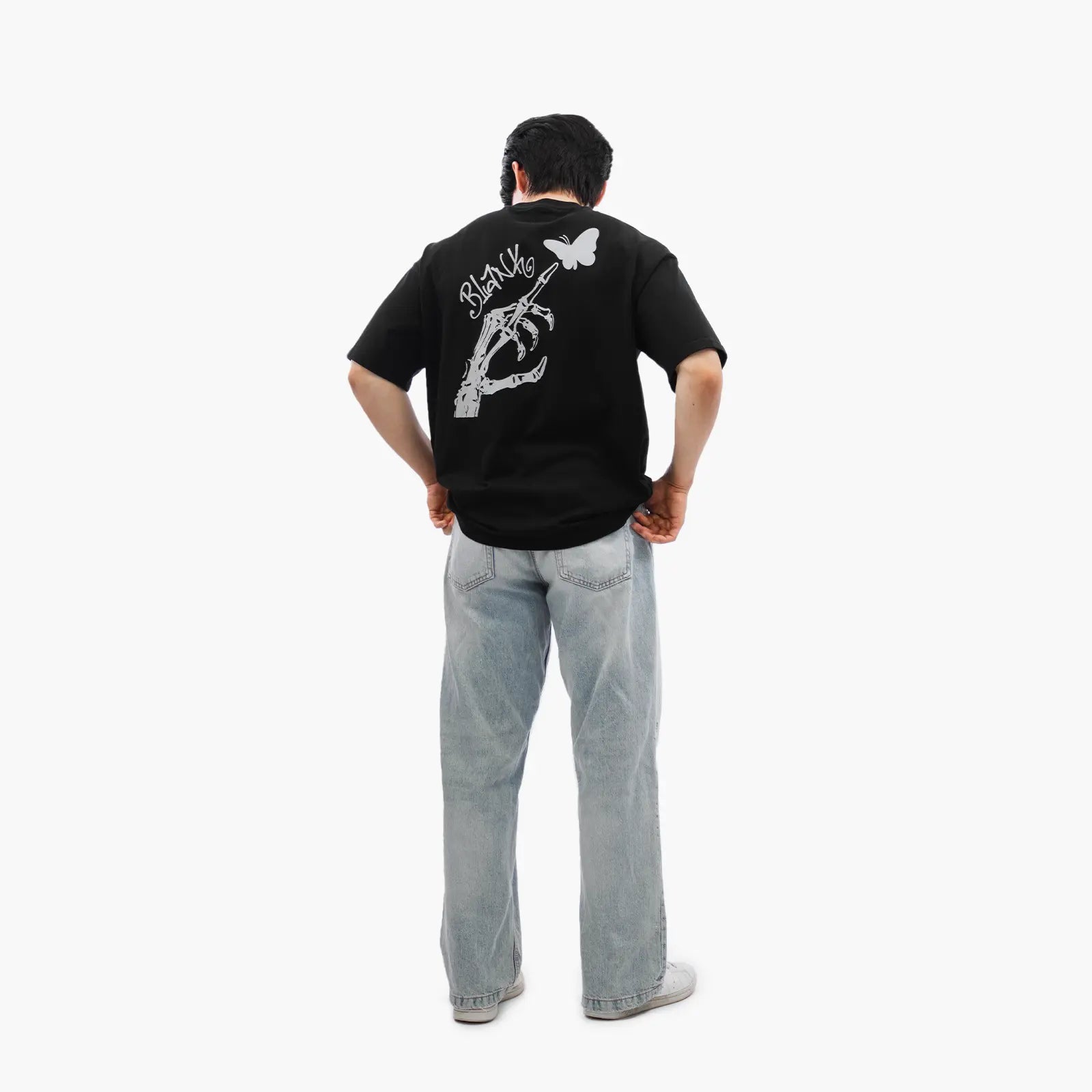 Model wears Blank Project Skeleton Hand Graphic Short Sleeve T-Shirt in black color