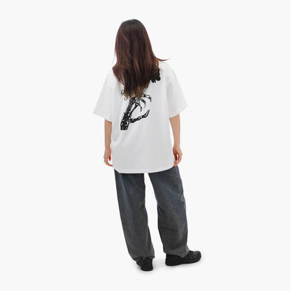 Model wears Blank Project Skeleton Hand Graphic Short Sleeve T-Shirt in white color