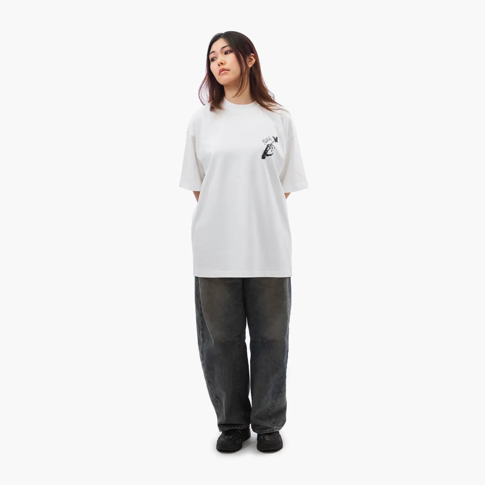 Model wears Blank Project Skeleton Hand Graphic Short Sleeve T-Shirt in white color