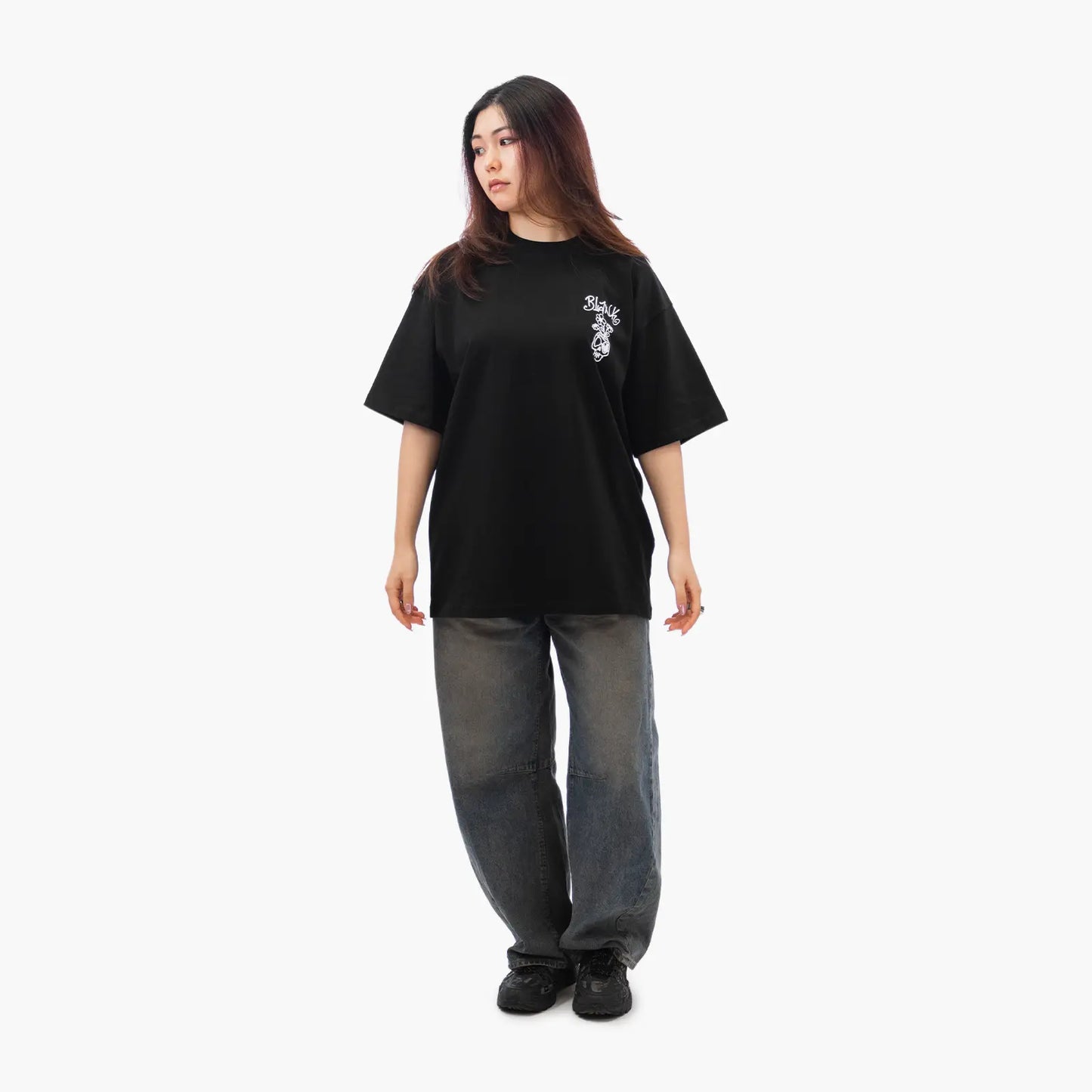 Model wears Blank Project Flower Skull Graphic Short Sleeve T-Shirt in Black Color