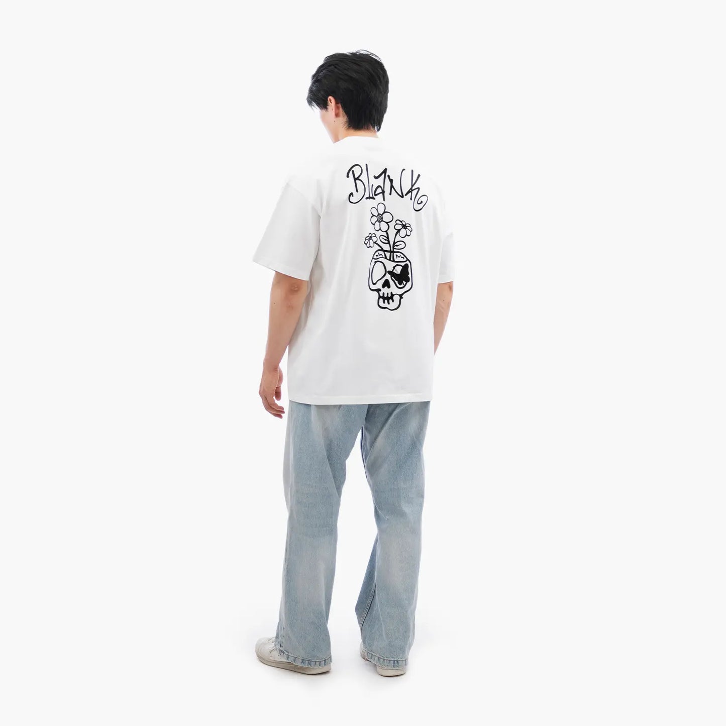 Model wears Blank Project Flower Skull Graphic Short Sleeve T-Shirt in White Color
