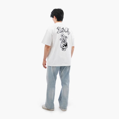 Model wears Blank Project Flower Skull Graphic Short Sleeve T-Shirt in White Color