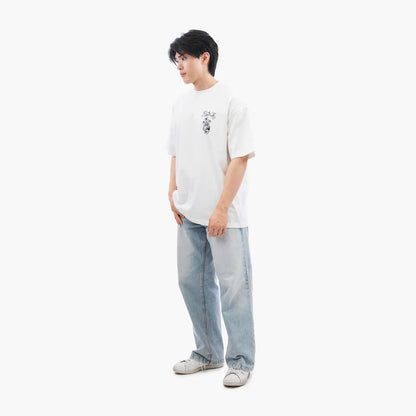 Model wears Blank Project Flower Skull Graphic Short Sleeve T-Shirt in White Color