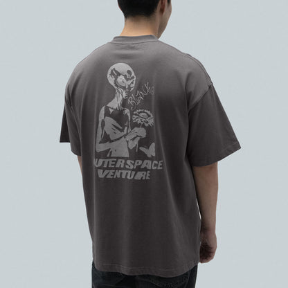 Model wearing Blank Project alien with flower and butterfly grahpic short sleeve t-shirt in charcoal gray color