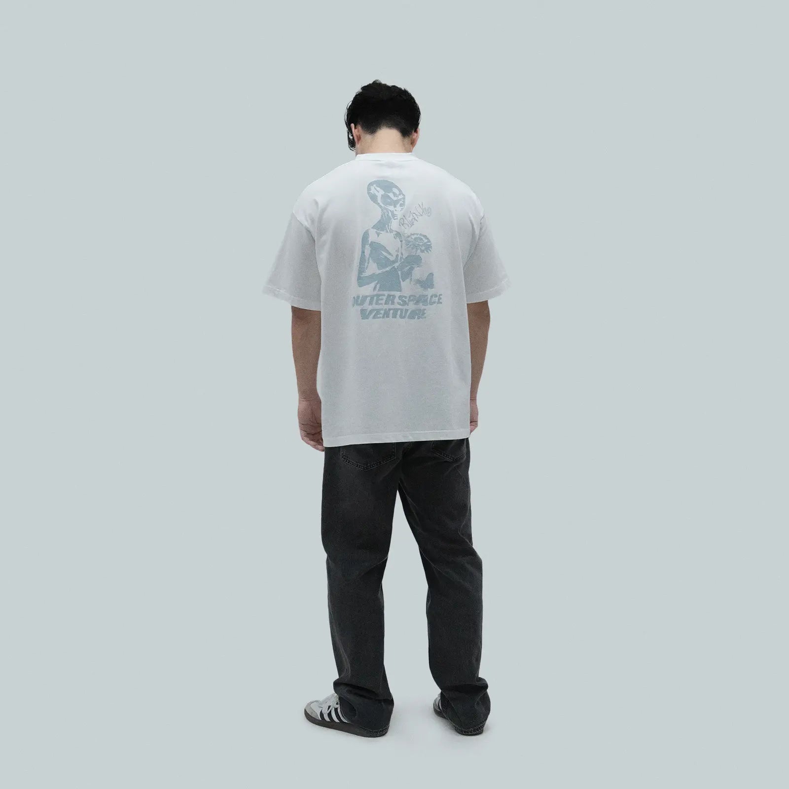 Model wearing Blank Project alien with flower and butterfly graphic short sleeve t-shirt in white color