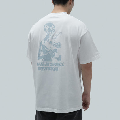 Model wearing Blank Project alien with flower and butterfly graphic short sleeve t-shirt in white color